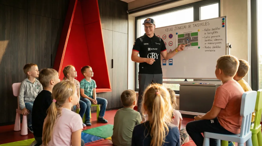 Rokas Baciuška teaching road safety rules to children in a classroom as part of GBY Group safety campaign